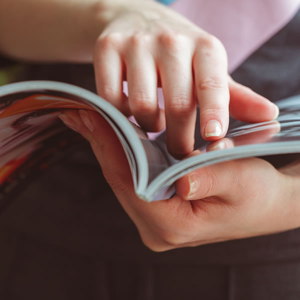 Close up of person reading a magazine